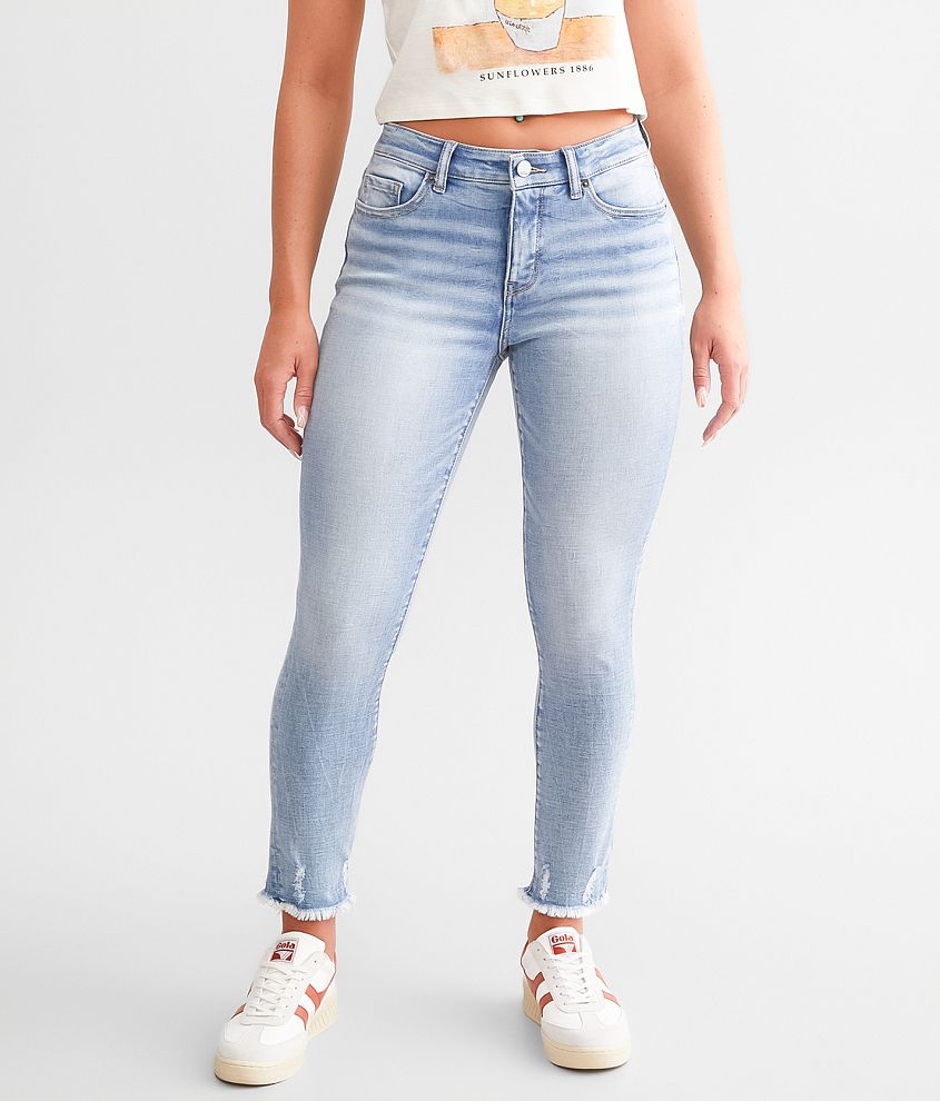 skinny ankle jeans with frayed bottom hem and destruction